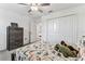 Comfortable bedroom with a gray dresser, closet, and a bed with dinosaur-themed bedding and cute stuffed animals at 22229 Storybook Cabin Way, Land O Lakes, FL 34637