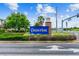 A blue and gold 'Connerton' community welcome sign with a brick pillar at 22229 Storybook Cabin Way, Land O Lakes, FL 34637