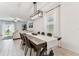 Bright dining area featuring a rustic wooden table, modern light fixture, and open layout at 22229 Storybook Cabin Way, Land O Lakes, FL 34637
