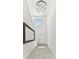 Elegant hallway with high ceilings, decorative mirror, and a stylish chandelier at 22229 Storybook Cabin Way, Land O Lakes, FL 34637