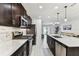 Modern kitchen with stainless steel appliances, quartz countertops, subway tile backsplash and dark wood cabinetry at 22229 Storybook Cabin Way, Land O Lakes, FL 34637