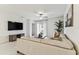 Bright living room featuring a comfortable leather sofa, stylish decor, and a view to the outdoor patio at 22229 Storybook Cabin Way, Land O Lakes, FL 34637