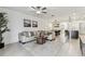 Spacious living room with tile floors, modern furnishings, and an open layout connecting to the kitchen and dining areas at 22229 Storybook Cabin Way, Land O Lakes, FL 34637