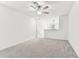 A sizable loft space with neutral carpet, fan, and a window provides a versatile area for relaxation or entertainment at 22229 Storybook Cabin Way, Land O Lakes, FL 34637