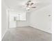 A sizable loft space with neutral carpet, fan, and a window provides a versatile area for relaxation or entertainment at 22229 Storybook Cabin Way, Land O Lakes, FL 34637