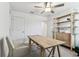 Well-lit office featuring a wooden desk, storage shelving, and a comfortable chair, designed for productivity and style at 22229 Storybook Cabin Way, Land O Lakes, FL 34637