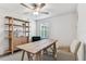 This office includes a wooden desk, bookshelf, and comfortable chair, creating an ideal workspace at home at 22229 Storybook Cabin Way, Land O Lakes, FL 34637