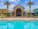 Gorgeous exterior view of the 'Splash Condos' clubhouse with a pool and lush landscaping at 22229 Storybook Cabin Way, Land O Lakes, FL 34637