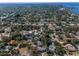 Stunning aerial view of a lush residential area with mature trees and beautiful homes at 223 Lime S Cir, Dunedin, FL 34698