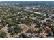 Extensive aerial view of the homes and neighborhoods surrounded by lush greenery at 223 Lime S Cir, Dunedin, FL 34698