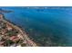 Beautiful aerial view of waterfront homes along the coast with clear blue water and scenic road at 223 Lime S Cir, Dunedin, FL 34698