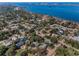 Scenic aerial view of a residential neighborhood near the water and city skyline at 223 Lime S Cir, Dunedin, FL 34698