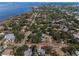 Aerial view of a charming waterfront town showcasing residential area and serene coastline at 223 Lime S Cir, Dunedin, FL 34698