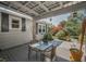 Comfortable backyard patio perfect for outdoor dining and entertaining with lush landscape at 223 Lime S Cir, Dunedin, FL 34698