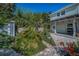 Picturesque backyard with lush greenery, shed and outdoor seating area at 223 Lime S Cir, Dunedin, FL 34698