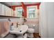Cozy bathroom featuring a pedestal sink, decorative tile, and updated fixtures at 223 Lime S Cir, Dunedin, FL 34698