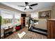 Bright bedroom with large windows, ceiling fan, and exercise equipment at 223 Lime S Cir, Dunedin, FL 34698