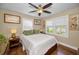 Comfortable bedroom with natural light, ceiling fan and hardwood floors at 223 Lime S Cir, Dunedin, FL 34698