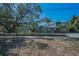 Charming two-story home with vibrant landscaping, mature trees, and inviting curb appeal at 223 Lime S Cir, Dunedin, FL 34698