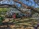 Charming home with mature landscaping, shade trees, and well-kept lawn at 223 Lime S Cir, Dunedin, FL 34698