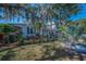 Charming home with mature landscaping and a well-kept lawn in a quiet neighborhood at 223 Lime S Cir, Dunedin, FL 34698