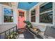 Charming front porch with blue ceiling, sitting bench and colorful accents at 223 Lime S Cir, Dunedin, FL 34698