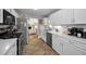 Contemporary kitchen with white cabinets, subway tile backsplash, and stainless steel appliances at 223 Lime S Cir, Dunedin, FL 34698