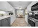 Spacious kitchen with stainless steel appliances, white cabinets, and a cozy breakfast nook at 223 Lime S Cir, Dunedin, FL 34698