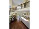 Spacious living room with hardwood floors, stylish furnishings, and staircase at 223 Lime S Cir, Dunedin, FL 34698
