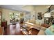 Comfortable living room with hardwood floors, a neutral sofa, and plenty of natural light at 223 Lime S Cir, Dunedin, FL 34698