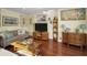 Cozy living room featuring rich hardwood floors, comfortable seating, and stylish decor at 223 Lime S Cir, Dunedin, FL 34698