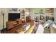 Bright living room features hardwood floors, a cozy sofa, and natural light from the large window at 223 Lime S Cir, Dunedin, FL 34698
