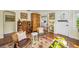 Warm living room with beautiful hardwood floors and vintage accents leading to the kitchen at 223 Lime S Cir, Dunedin, FL 34698