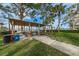 Outdoor picnic area with covered pavilion, tables, and beautiful views of the water and boats at 223 Lime S Cir, Dunedin, FL 34698
