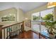 Well-lit staircase with hardwood steps and railing, plus views from upper window at 223 Lime S Cir, Dunedin, FL 34698
