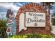Charming welcome sign to Dunedin featuring a bagpiper statue and brick archway at 223 Lime S Cir, Dunedin, FL 34698