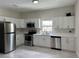 Modern kitchen featuring stainless steel appliances, white cabinets, and ample counter space at 2423 E 19Th Ave, Tampa, FL 33605