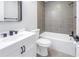 This bathroom boasts a white vanity, black fixtures, and a tub with gray tile surround at 2489 Oakleaf Ln # 21C, Clearwater, FL 33763