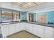 Kitchenette with updated white appliances, long countertops, and a pass-through window at 2489 Oakleaf Ln # 21C, Clearwater, FL 33763
