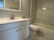 Bathroom with white vanity, updated sink fixtures, and modern tiled shower with tub combination at 2571 Cyprus Dr # 1-102, Palm Harbor, FL 34684