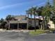 Attractive multi-story building featuring stucco walls, terracotta roofing, spiral staircases, and lush landscaping at 2571 Cyprus Dr # 1-102, Palm Harbor, FL 34684