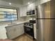 Modern kitchen with stainless steel appliances, sleek countertops, and ample cabinet space at 2571 Cyprus Dr # 1-102, Palm Harbor, FL 34684