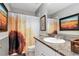 Bathroom with granite vanity, framed artwork and a sunflower shower curtain adding a vibrant touch at 2837 Bayshore Trails Dr, Tampa, FL 33611