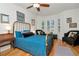 Bright bedroom featuring a bed with plush pillows, hardwood floors, and natural light from the windows at 2837 Bayshore Trails Dr, Tampa, FL 33611