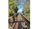 Picturesque view of a wooden dock leading to the water, framed by lush greenery and a clear blue sky at 2837 Bayshore Trails Dr, Tampa, FL 33611