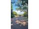 Brick-paved entrance featuring secure gates, lined with mature trees, offering privacy and an inviting approach at 2837 Bayshore Trails Dr, Tampa, FL 33611