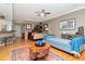 Comfortable living room featuring hardwood floors, a ceiling fan, stylish furniture, and bright decor at 2837 Bayshore Trails Dr, Tampa, FL 33611