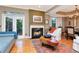 Bright living area featuring hardwood floors, a fireplace, and access to the outdoor patio at 2837 Bayshore Trails Dr, Tampa, FL 33611