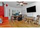 Versatile office space with hardwood floors, a ceiling fan, and a large window, offering ample workspace at 2837 Bayshore Trails Dr, Tampa, FL 33611