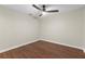 A minimalist bedroom features neutral walls, modern ceiling fan, and wood-look floors at 301 71St S St, St Petersburg, FL 33707